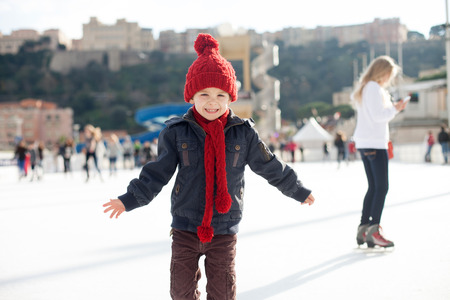 Happy boy with red hat, skating during the day, having funの写真素材