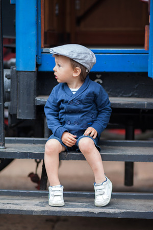 Portrait of a little boy in a old steam trainの写真素材