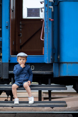 Portrait of a little boy in a old steam trainの写真素材