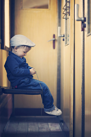 Portrait of a little boy in a old steam trainの写真素材