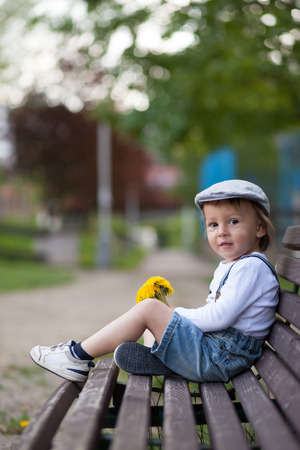 Portrait of a little boy with dandelionsの写真素材