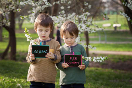 Two boys, holding boards with signsの写真素材