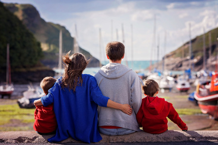 Young family with small kids on a harbor in the afternoonの写真素材