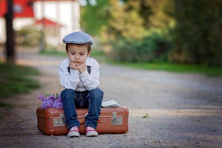 Little boy with suitcase and map, travelingの写真素材