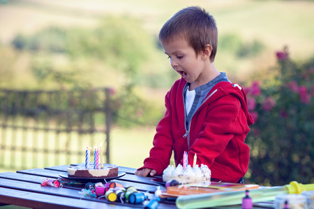 Cute boy, celebrating his birthday outdoor, summertime