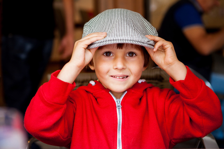 Close portrait of Handsome Young Boy with flat cap, outdoorsの写真素材