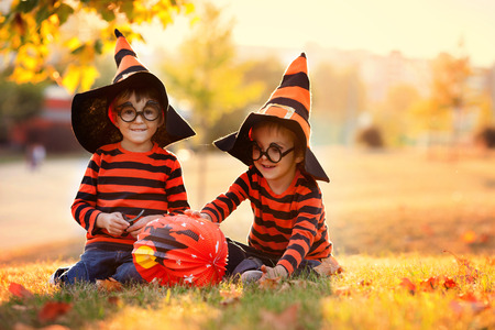 Two boys in the park with Halloween costumes, having funの写真素材