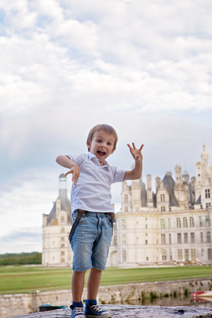 Cute boy, having fun outdoor, summertime in front of Chambord chateauxの写真素材