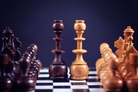 Chess figures on a chess board, symmetrically set on the boardの写真素材