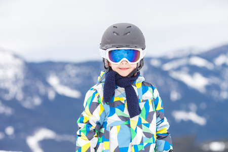 Young preschool child, skiing on snow slope in ski resort in Austria, wintertimeの写真素材