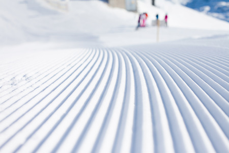 Snow lines made from a snow machine on a ski slopeの写真素材