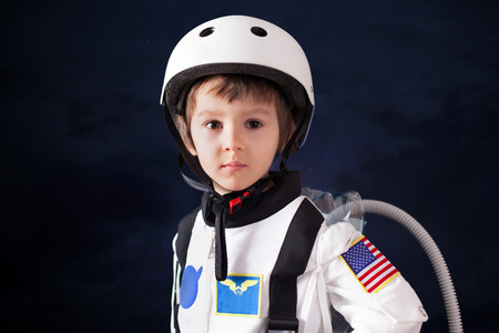 Beautiful portrait of preschool boy, dressed as astronaut, proudly standingの写真素材