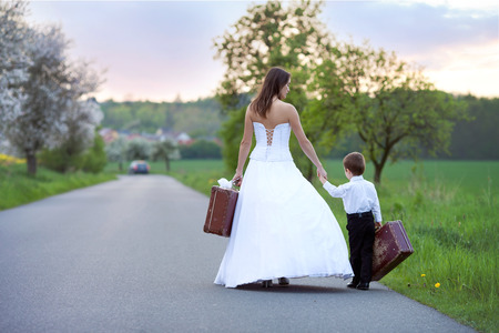 Young bride on the road with a suitcaseの写真素材