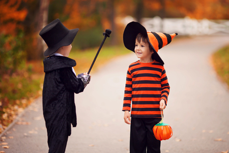 Two boys in the park with Halloween costumes, having funの写真素材
