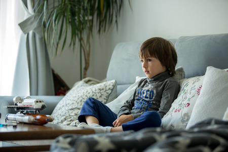 Cute little child, preschool boy, playing at home in living room with toys, having funの写真素材