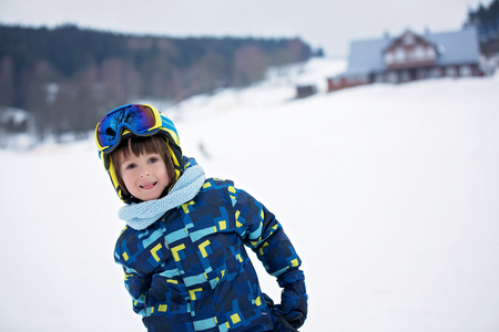Cute child, skiing in the mountain, wintertimeの写真素材