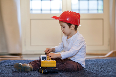 Child, boy, playing at home with plastic excavatorの写真素材