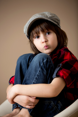 Sweet preschool boy, making faces with different emotion, isolated imageの写真素材