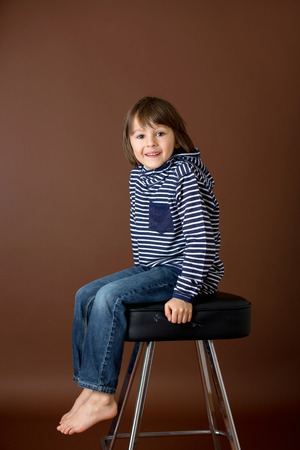 Sweet preschool boy, making faces with different emotion, isolated imageの写真素材