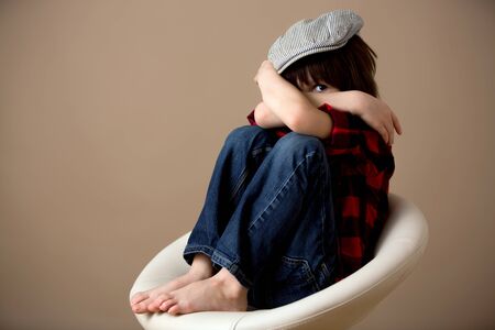 Sweet preschool boy, making faces with different emotion, isolated imageの写真素材