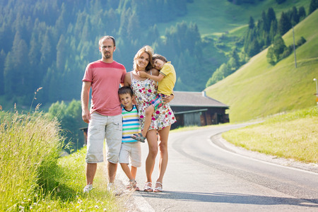 Young beautiful family, traveling in Swiss Alps on summer holidayの写真素材