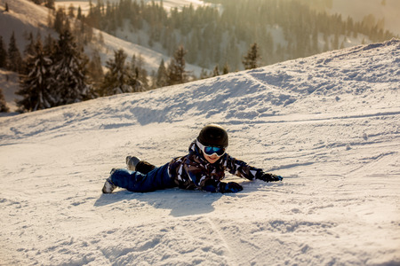 Cute preschool child, boy, skiing happily in Austrian Apls on a sunny beautiful snowy dayの写真素材