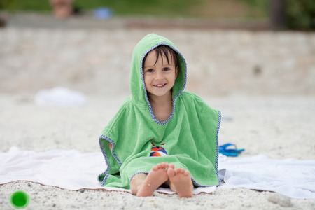 Cute little preschooler boy, playing in the sand on the beach with beach toys, Monaco beach, Europeの写真素材