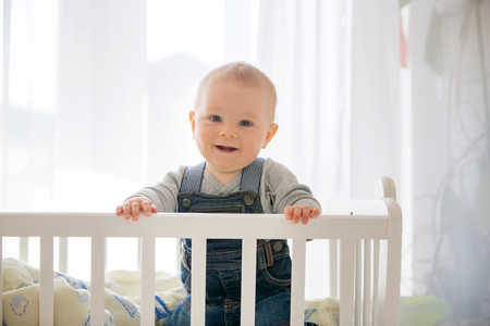 Smiling toddler boy in crib.の写真素材
