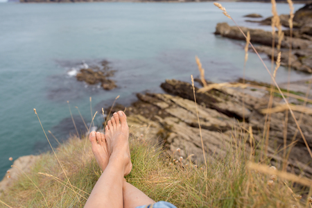 Children, enjoying quiet cloudy day on the ocean shore on the cliff, rocky beach in England