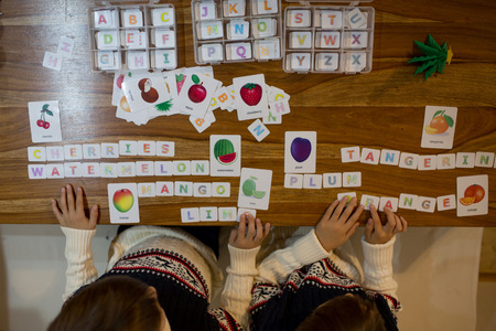 Children, writing words with cut letters and learning english words, educational game for preschool childrenの写真素材