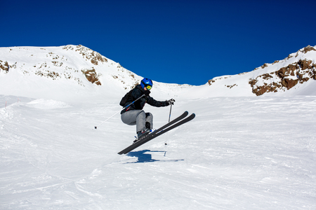 Happy people, children and adults, skiing on a sunny day in Tyrol mountains. Kids having fun while skiingの写真素材