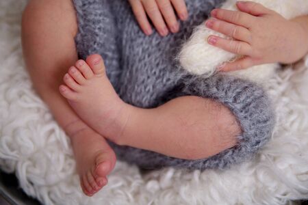 Newborn baby boy, sleeping peacefully in basket, dressed in knitted outfit, chilling out, happy and...