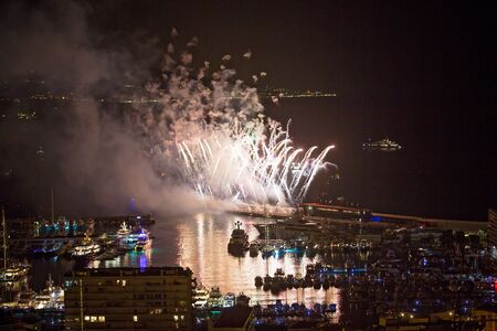 Panoramic lovely view of fireworks on the Principality of Monaco on a stormy dayの写真素材