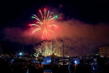Panoramic lovely view of fireworks on the Principality of Monaco on a stormy dayの写真素材