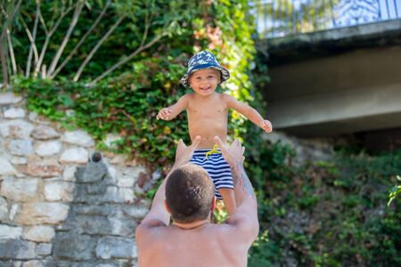 Family portrait on the beach, children and parents having fun togetherの写真素材