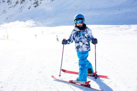Happy people, children and adults, skiing on a sunny day in Tyrol mountains. Kids having fun while skiingの写真素材