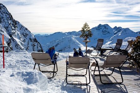 Happy people, children and adults, skiing on a sunny day in Tyrol mountains. Kids having fun while skiingの写真素材