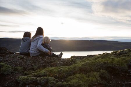 Family posing in Geothermal area in Reykjanesfolkvangur, enjoying the view of a splendid nature in...
