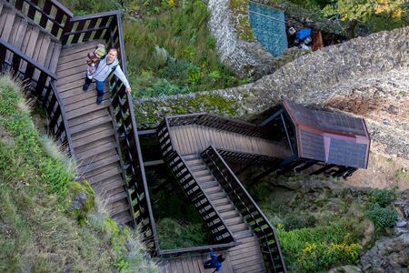 Wodeen staircase, going to castle in the forest, people walking downstairsの写真素材