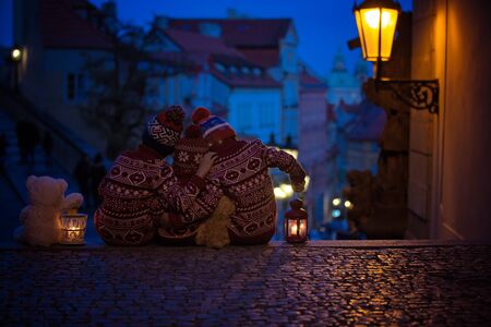 Beautiful children, three boy brothers, casually dressed, looking at night view of Prague city, wintertimeの写真素材