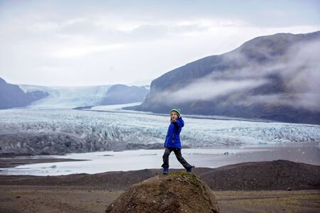 Children posing in beautiful aerial view of the nature in Skaftafell Glacier national park on a gorgeous autumn day in Icelandの写真素材
