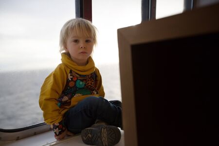 Children, playing on a ferry boat while traveling from Helsinky to Tallinnの写真素材