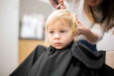 Cute little boy, having haircut, smilingの写真素材