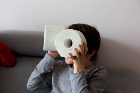 Child, playing with toilet paper ato homeの写真素材