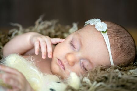 Close portrait of newborn baby girl in studio