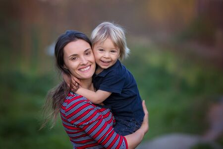 Spring portrait of happy family in nature on sunset, having fun together