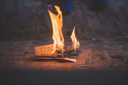 Preteen child, burning paper in the attic, seting it on fireの写真素材