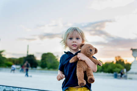 Little toddler child, blond boy, visiting Paris during summertime