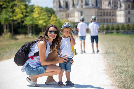 Mother and children walking on the premises of Chambord castle on Loire valley in France on a summer dayの写真素材