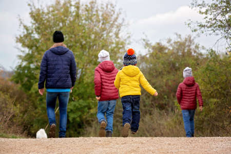 Happy children, running and jumping and playing in autumn park